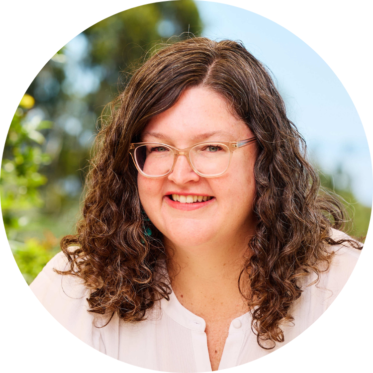 Picture of Loren Farrar. Loren appears in front of a nature background and wears a white top and clear glasses.
