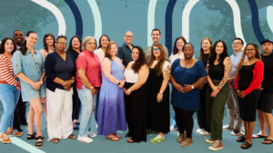 Magic Cabinet Team members appear in front of blue background with bold stripes appearing behind them.