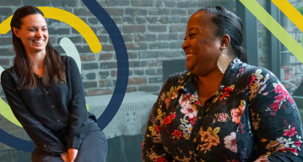 Two women appear in front of a semi-transparent background featuring a brick wall. Multi-colored pathways appear behind them.